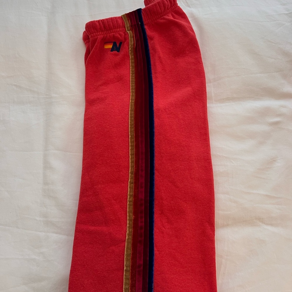 Adidas Red Track Pants with Multicolor Stripes
